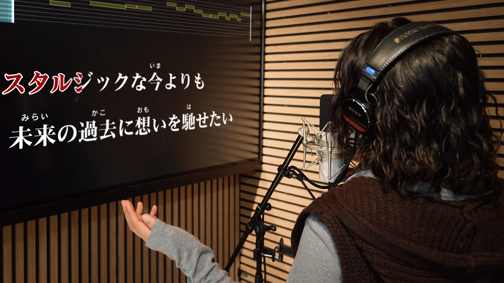 A guest stepping out of the booth after a session