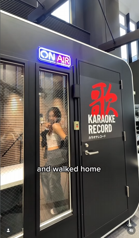 Outside the black booth with the ON AIR sign glowing